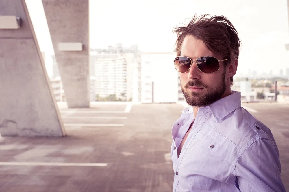 Ben Fein in sunglasses on a rooftop car park